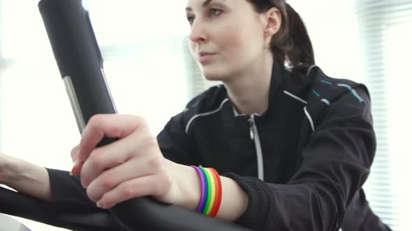 Girl with LGBT Symbols on the Bike Simulator