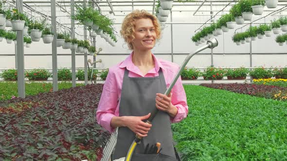 Portrait Blonde Woman is Happy to Watering and Care for Flower Seedlings