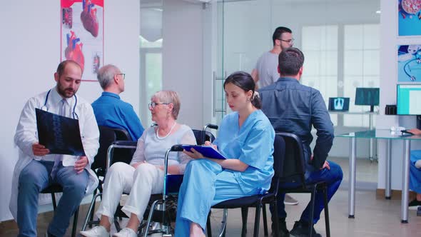 Doctor Discussing Diagnosis with Disabled Senior Woman