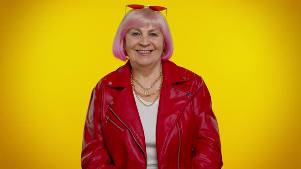Cheerful Stylish Senior Granny Woman with Pink Hair in Red Leather Jacket Smiling Looking at Camera
