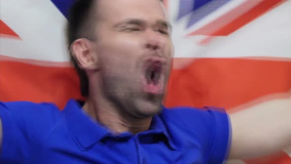 British Fan Celebrating While Holding the British Flag