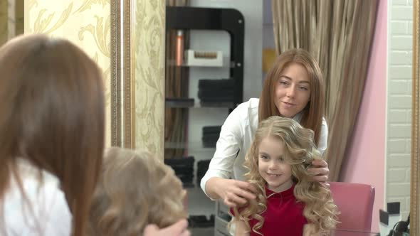 Smiling Little Girl and Hairdresser