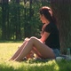 Young Woman In Park Uses Smartphone And Tablet - VideoHive Item for Sale