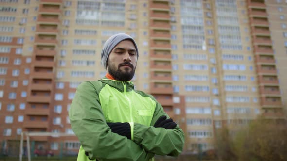 Professional Middle Eastern Athlete Posing for Camera Outdoors