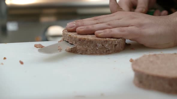 cutting hamburger and preparing it to cooking