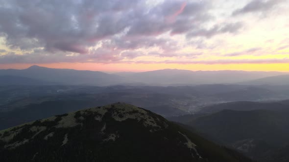 Aerial View of Amazing Scenery with Foggy Dark Mountain Peak Covered with Forest Pine Trees at