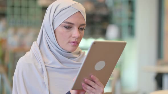 Portrait of Focused Young Arab Woman Using Digital Tablet 