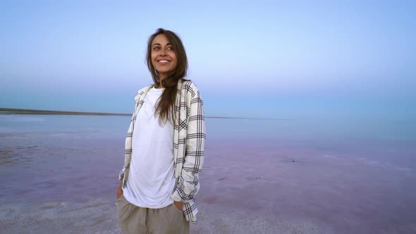 Happy Joyful Woman Enjoying Nature Landscape at Pink Salt Lake at Evening