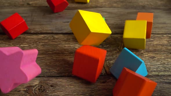 Children's play wooden figures fall on a vintage board. Slow motion.