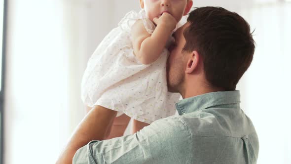 Happy Father Kissing Little Baby Daughter 1