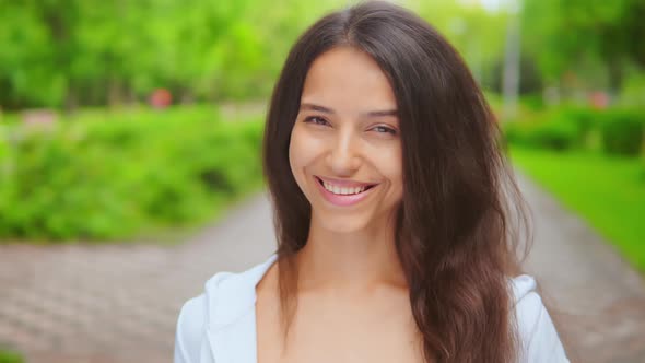 Cheerful Girl Portrait in City with Spring Green on Background