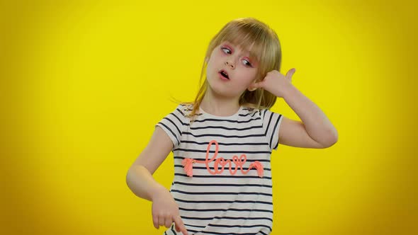 Funny Playful Child Girl Looking at Camera Doing Phone Gesture Like Says Hey you Call Me Back