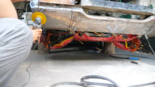 Mechanic Polishing Auto with Electric Tool at Workshop