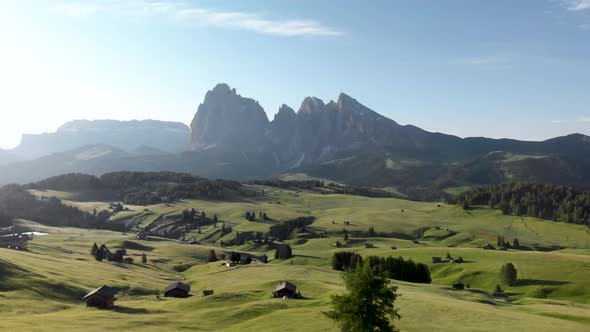 Drone Flying over  Seiser Alm Valley with Traditional Wooden Mountain Huts in Dolomites  Italy