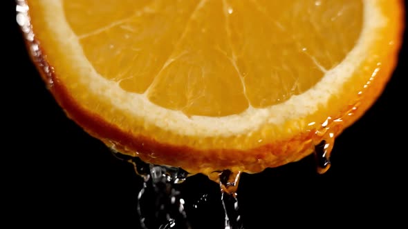 Water Splashing on Fresh Orange in Slow Motion