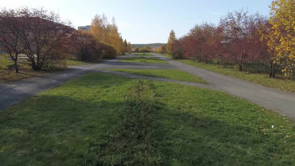 Drone view of park with trees in provincial city with soviet panel houses 32