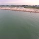 Aerial Shot of Black Sea Beach with Tourists, Sunshades, Hotels and Greenery - VideoHive Item for Sale