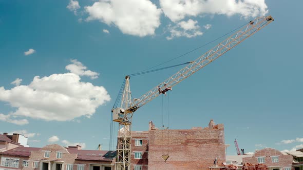 Aerial Drone View of Construction Cranes in Sunny Day. Construction Site Building in City.