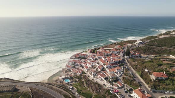 Azenhas Do Mar coastline cliff town in Portugal seaside, aerial drone view