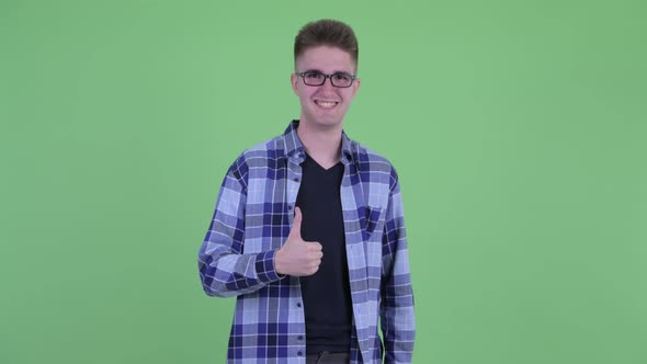 Happy Young Handsome Hipster Man Giving Thumbs Up