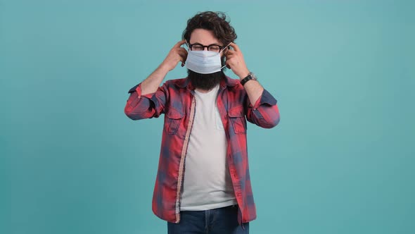 Bearded Man Puts a Mask on His Face From Air Pollution and Coronavirus