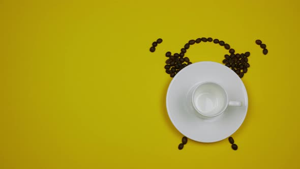 A Cup of Coffee and Coffee Beans Forming an Alarm Clock on the Yellow Background
