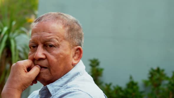 Senior man relaxing in garden