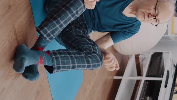 Vertical Video Calm Pensioner in Lotus Position Doing Meditation to Relax