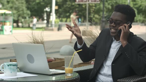 Afro-American Businessman Negotiating By Phone, Defending His Interests and Opinion