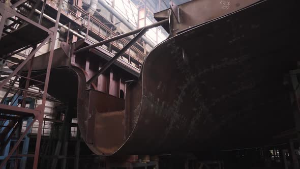 Section of Old Crab Ship and Worker in Empty Hold in Dock