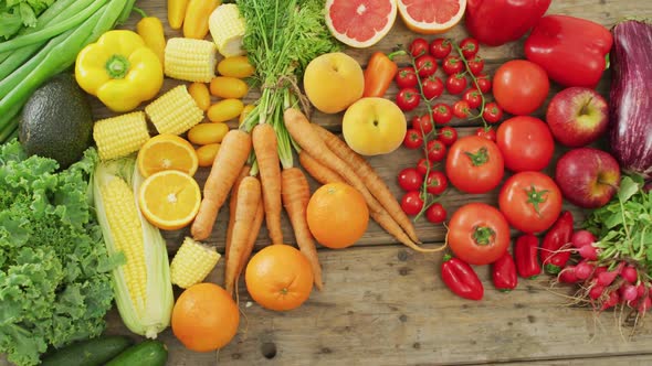 Video of fresh fruit and vegetables over wooden background