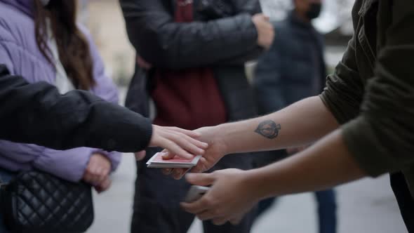 Magician Man Showing Street Magic Trick with Cards