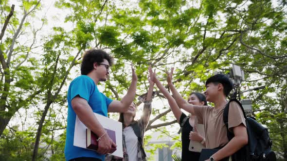 Happy group of student friends greeting together in college. Education and student.