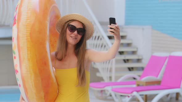 Attractive European Blonde Girl in Swimsuit Travel Blogger Makes Selfie Live Broadcast Recording