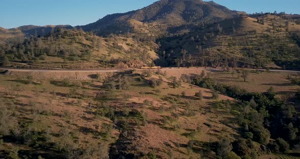 Distant train passing through Tehachapi, California, Aerial Side Tracking Pan