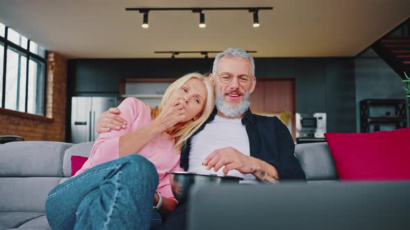 Married Couple Have a Fan Sitting on the Couch and Watching a Movie