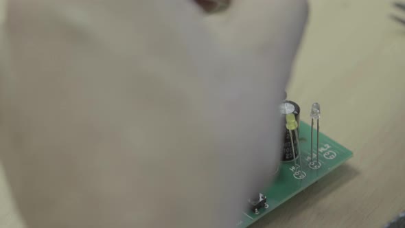 A Worker Is Working on the Production of an Electronic Board. Close-up.