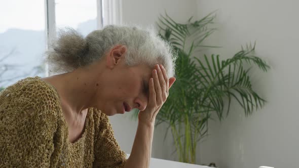 Animation of caucasian senior woman feeling bad, having headache