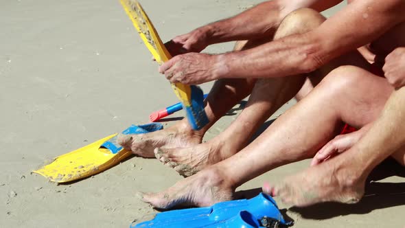 Senior couple wearing flippers on beach