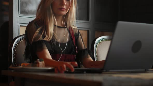 Beautiful Woman Working on Her Laptop on a Stylish Urban Restaurant