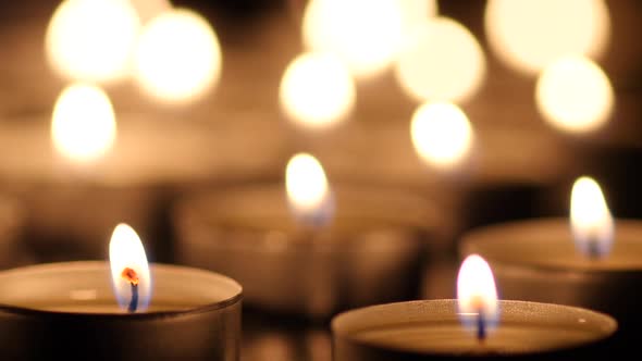 Many Candles Light on Black Background