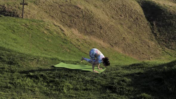 Woman Practicing Yoga in Nature