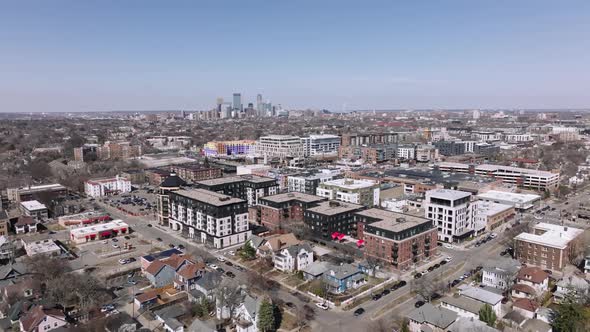 rotating aerial drone shot of uptown minneapolis with downtown minneapolis in the background