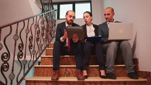 Business Partners Planingfinance Project Sitting on Staircase