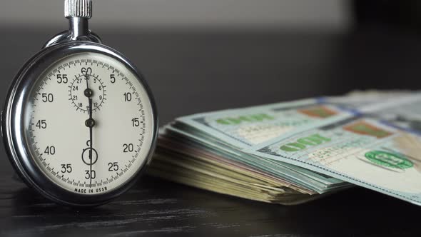 Dollars and stopwatch. Business concept of lost time and failed investments