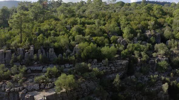 Aerial Drone View of Gray Rock Formations Among Green Pine Trees