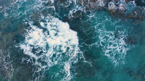 Aerial view of Waves rolling from above. Flying over sea water. 