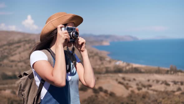 Adorable Relaxed Female Tourist Taking Picture of Beautiful Nature Using Camera Medium Shot