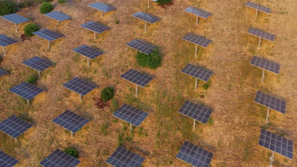 çAerial shot of a hillside in Southern California covered with solar panels