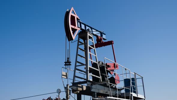 Oil Rig Stands in a Field at and Extracts Minerals